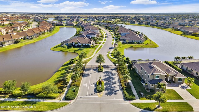 drone / aerial view featuring a water view and a residential view