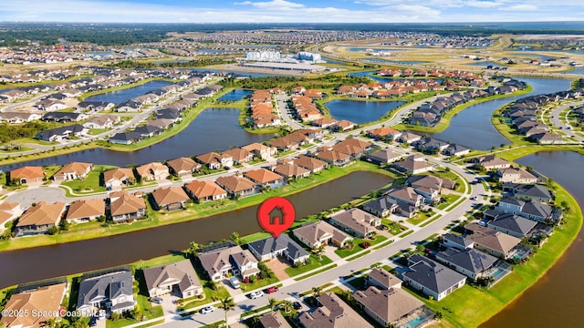 drone / aerial view featuring a residential view and a water view