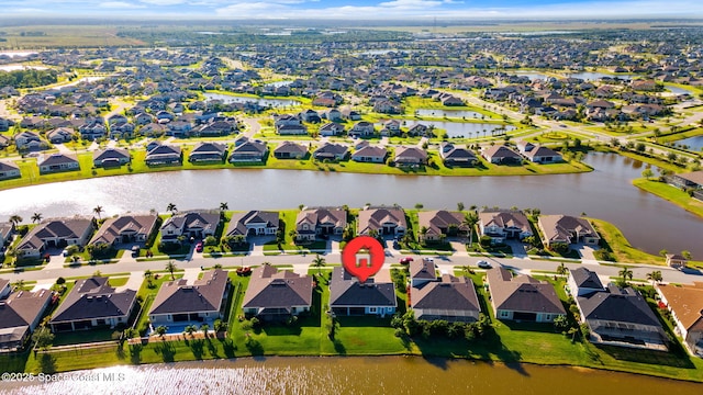 birds eye view of property featuring a water view and a residential view