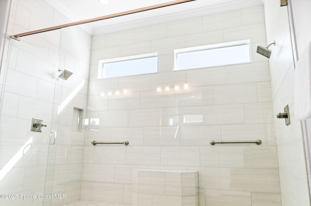 bathroom with crown molding and a stall shower
