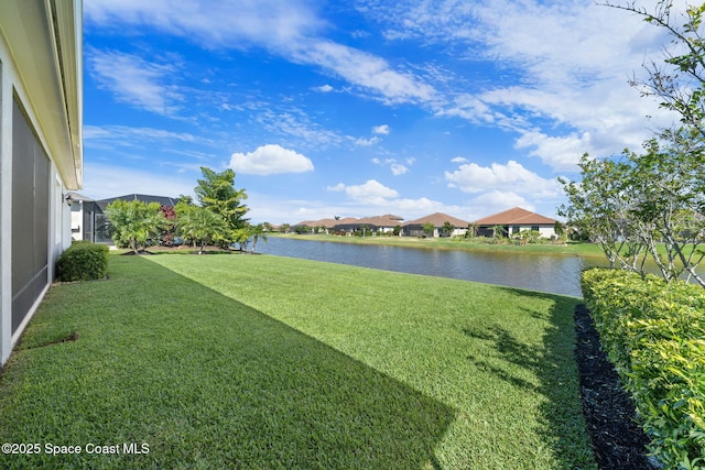 view of yard featuring a residential view and a water view