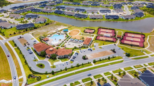 drone / aerial view with a residential view and a water view