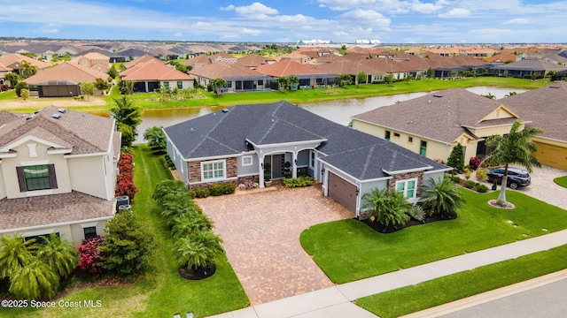 drone / aerial view with a residential view and a water view