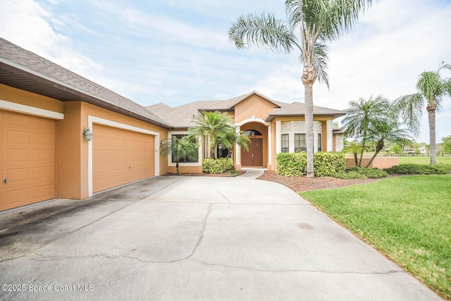 4068 Gardenwood Cir, Grant, FL 32949 - ranch-style home with stucco siding, driveway, a garage, and a front lawn