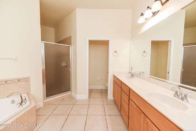4068 Gardenwood Cir, Grant, FL 32949 - bathroom with double vanity, toilet, a stall shower, a garden tub, and tile patterned flooring