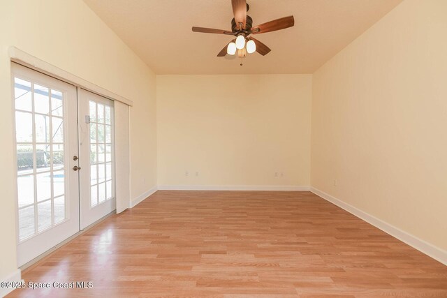 4068 Gardenwood Cir, Grant, FL 32949 - unfurnished room with french doors, light wood finished floors, a ceiling fan, and baseboards