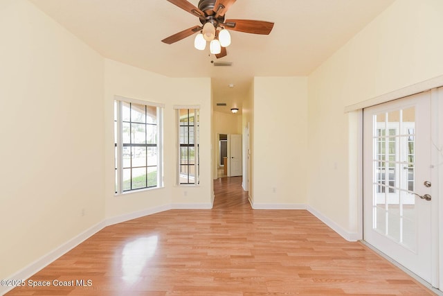 4068 Gardenwood Cir, Grant, FL 32949 - spare room with light wood-style flooring, ceiling fan, and baseboards