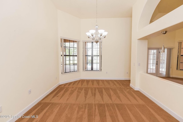 4068 Gardenwood Cir, Grant, FL 32949 - carpeted spare room with healthy amount of natural light, a chandelier, baseboards, and a towering ceiling