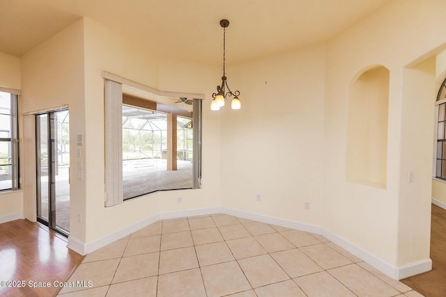 4068 Gardenwood Cir, Grant, FL 32949 - unfurnished dining area with plenty of natural light, a chandelier, and baseboards
