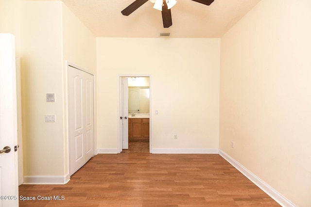 4068 Gardenwood Cir, Grant, FL 32949 - unfurnished bedroom with light wood-type flooring, baseboards, ensuite bathroom, and a ceiling fan