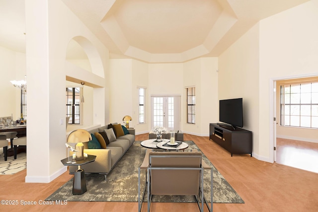 4068 Gardenwood Cir, Grant, FL 32949 - carpeted living room with a towering ceiling, baseboards, and a tray ceiling
