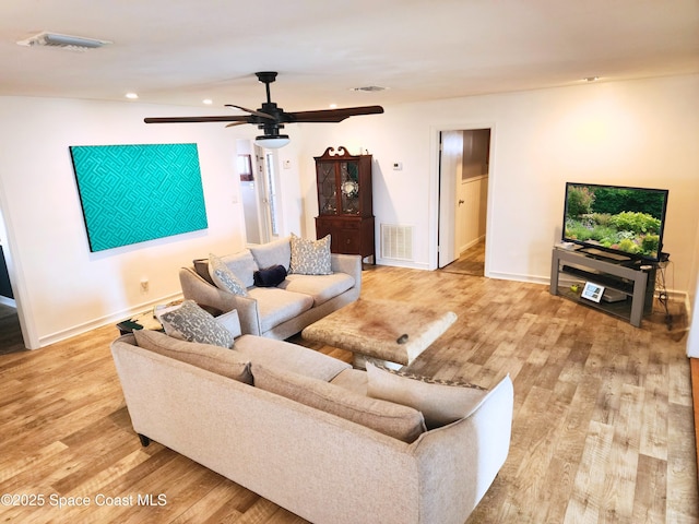 living area featuring wood finished floors, recessed lighting, ceiling fan, and baseboards
