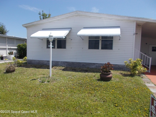 7637 Nianntic Ave Unit T5, Micco, FL 32976 - view of side of property featuring a lawn