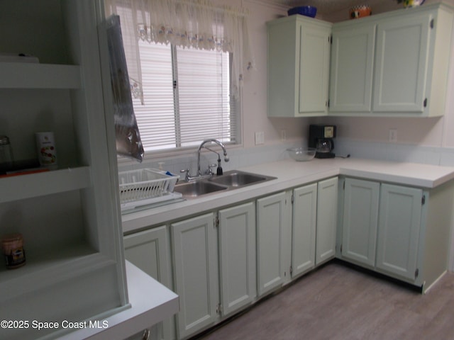 7637 Nianntic Ave Unit T5, Micco, FL 32976 - kitchen with light countertops, a sink, and light wood-style flooring