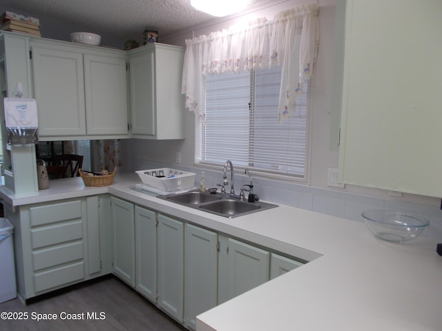 7637 Nianntic Ave Unit T5, Micco, FL 32976 - kitchen featuring a sink, light countertops, white cabinets, and a textured ceiling