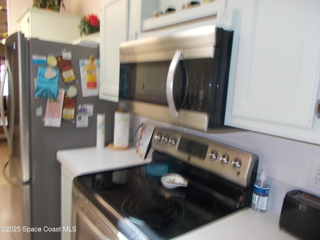7637 Nianntic Ave Unit T5, Micco, FL 32976 - interior details with white cabinets, light countertops, backsplash, and appliances with stainless steel finishes