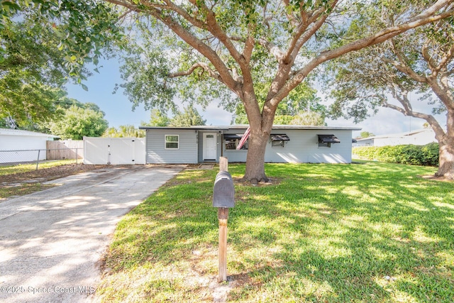2910 Tropic Rd, Melbourne, FL 32935 - single story home with driveway, fence, a front lawn, and a gate