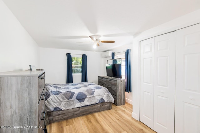 2910 Tropic Rd, Melbourne, FL 32935 - bedroom featuring a wall mounted air conditioner, light wood-type flooring, a closet, and a ceiling fan