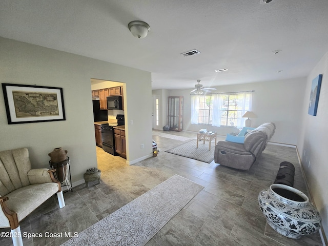 living room featuring visible vents, baseboards, and ceiling fan