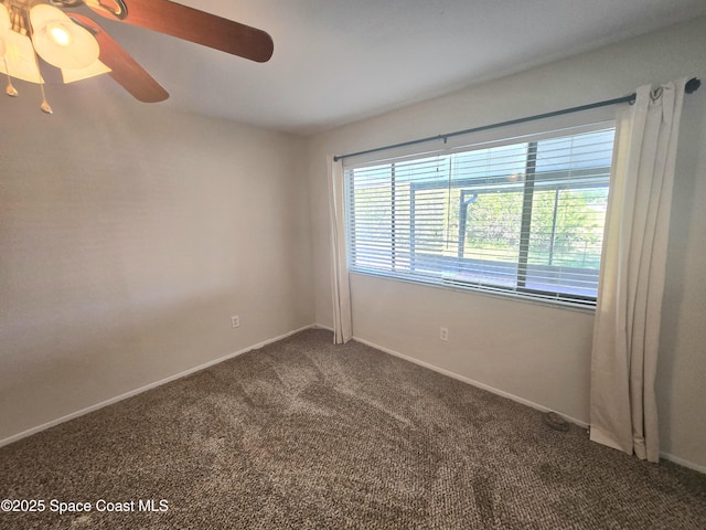 carpeted empty room with baseboards and a ceiling fan