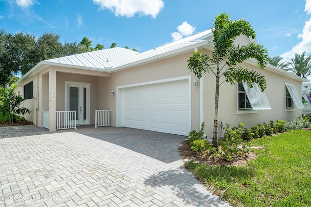 4280 Alamanda Key Dr, Melbourne, FL 32901 - view of front of home featuring a garage, stucco siding, and decorative driveway