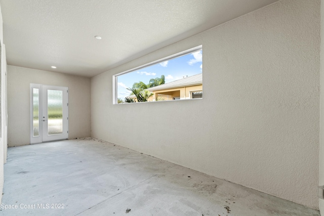 4280 Alamanda Key Dr, Melbourne, FL 32901 - spare room with unfinished concrete floors and french doors