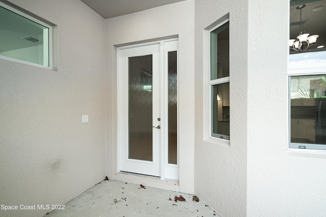 4280 Alamanda Key Dr, Melbourne, FL 32901 - property entrance with stucco siding and visible vents