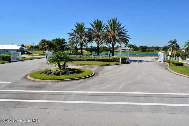 4280 Alamanda Key Dr, Melbourne, FL 32901 - view of street with curbs, a water view, a gated entry, and a gate