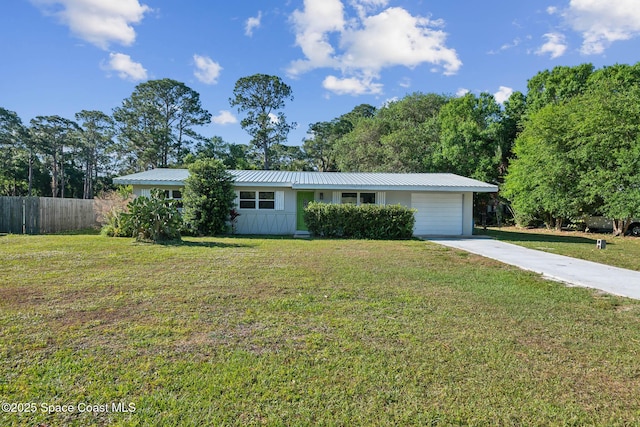 8575 Sheridan Rd, Melbourne, FL 32904 - ranch-style house with driveway, metal roof, and an attached garage