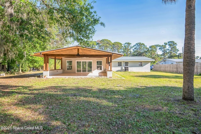 8575 Sheridan Rd, Melbourne, FL 32904 - rear view of house with a patio, stucco siding, and metal roof