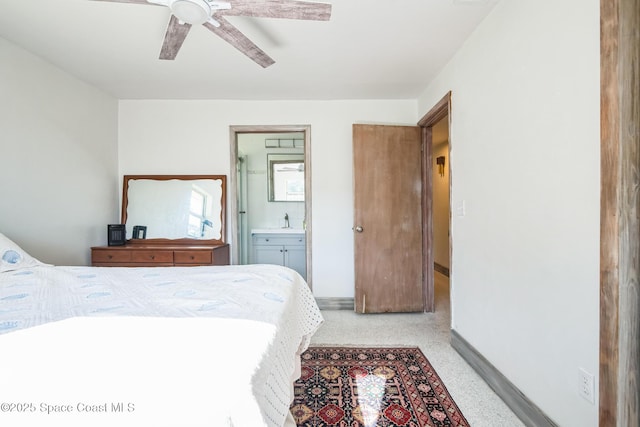 8575 Sheridan Rd, Melbourne, FL 32904 - bedroom with baseboards, ensuite bath, a ceiling fan, a sink, and dark speckled floor