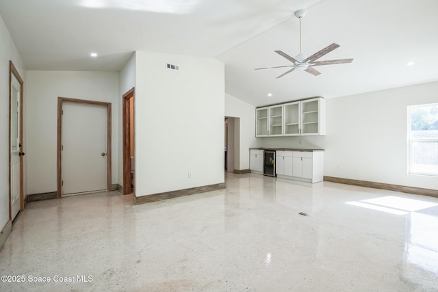 8575 Sheridan Rd, Melbourne, FL 32904 - unfurnished living room with baseboards, a ceiling fan, bar area, recessed lighting, and wine cooler