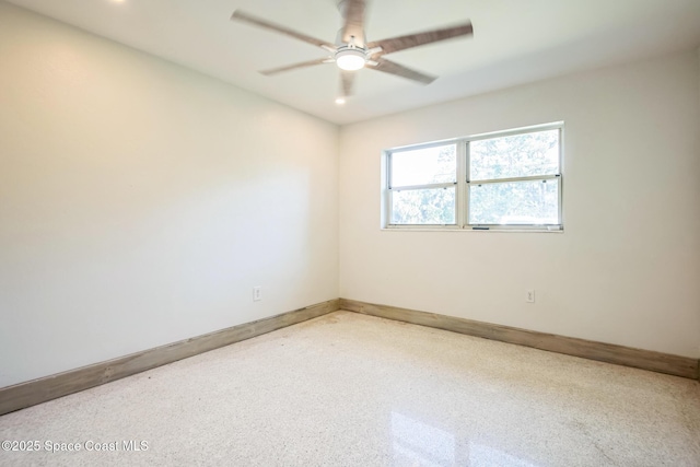 8575 Sheridan Rd, Melbourne, FL 32904 - empty room featuring ceiling fan, baseboards, and speckle patterned floor