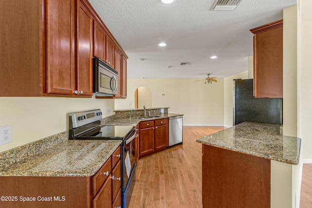 kitchen featuring a sink, visible vents, appliances with stainless steel finishes, and light wood-style floors