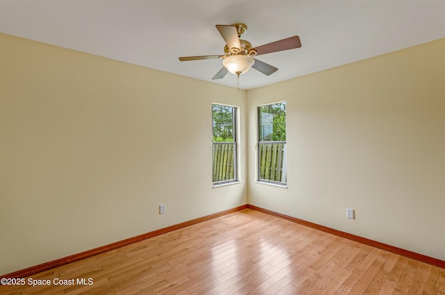unfurnished room with baseboards, light wood finished floors, and ceiling fan