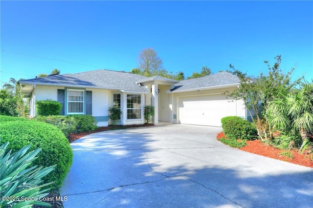 ranch-style house with an attached garage, a shingled roof, driveway, and stucco siding