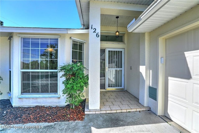 entrance to property featuring stucco siding