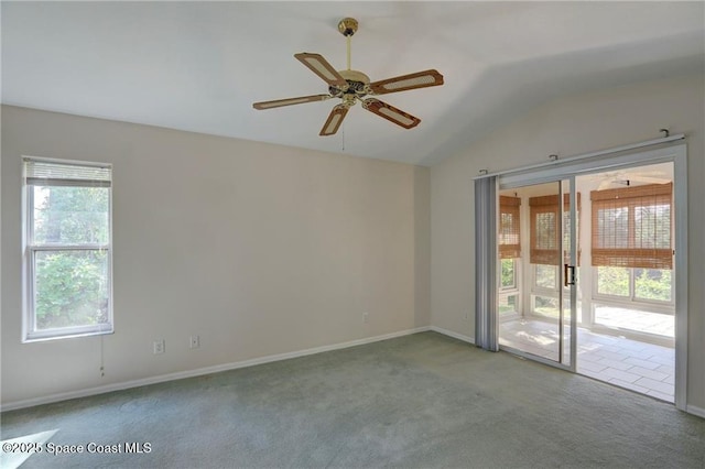 carpeted spare room with baseboards, a ceiling fan, and lofted ceiling