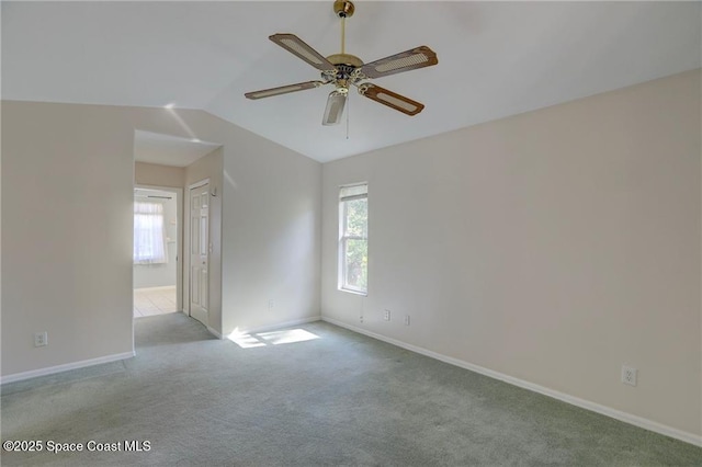 spare room featuring a wealth of natural light, a ceiling fan, carpet, and baseboards