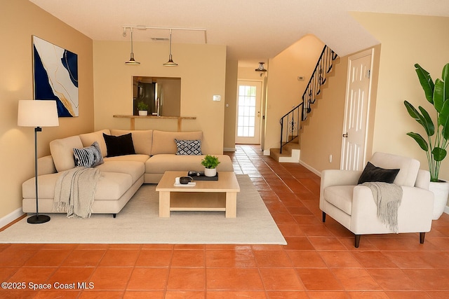 155 Kristi Dr, Indian Harbour Beach, FL 32937 - living room featuring tile patterned floors, stairway, and track lighting
