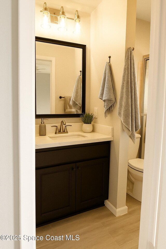 155 Kristi Dr, Indian Harbour Beach, FL 32937 - bathroom featuring vanity and wood finished floors