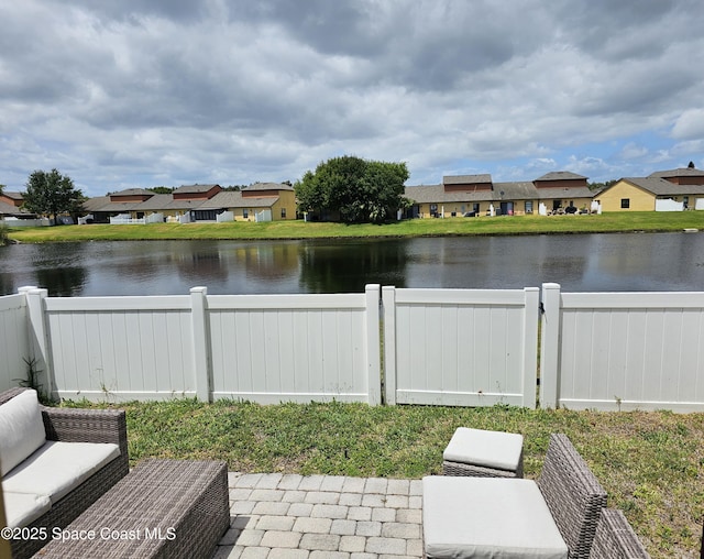 property view of water with a fenced backyard and a residential view