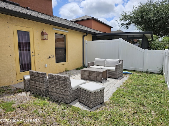 back of property with an outdoor hangout area, stucco siding, a fenced backyard, a patio area, and a lawn