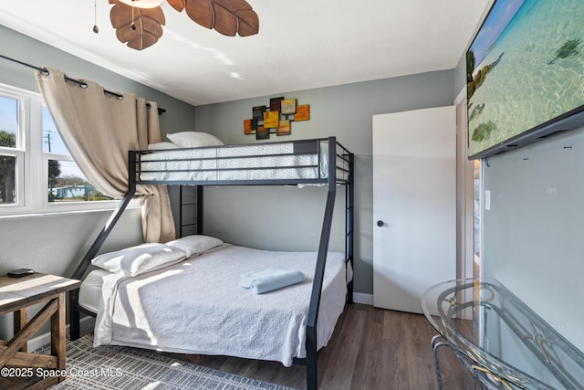 bedroom featuring baseboards, a ceiling fan, and wood finished floors