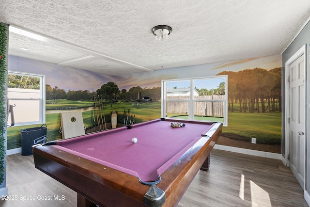 playroom with a healthy amount of sunlight, baseboards, billiards, and view of golf course