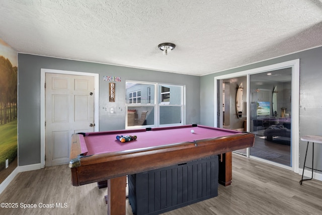 recreation room featuring pool table, baseboards, a textured ceiling, and wood finished floors