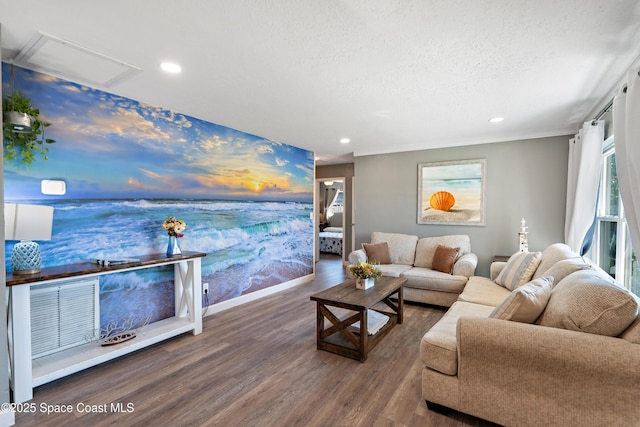 living room featuring visible vents, baseboards, a textured ceiling, recessed lighting, and wood finished floors