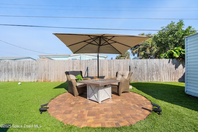 view of patio featuring fence and a fire pit
