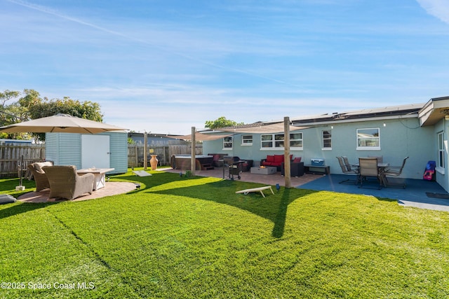 view of yard featuring a fenced backyard, an outdoor structure, a patio, and an outdoor hangout area