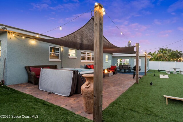 back of property featuring a patio area, stucco siding, fence, and a lawn